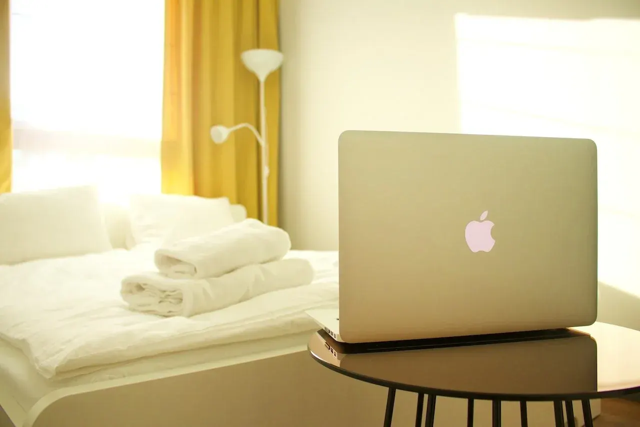 clean bed with laptop